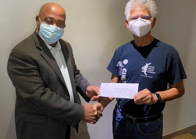 Dr Livingston Smith Receives His Grant from CNCF Artistic Director Henry Muttoo scaled